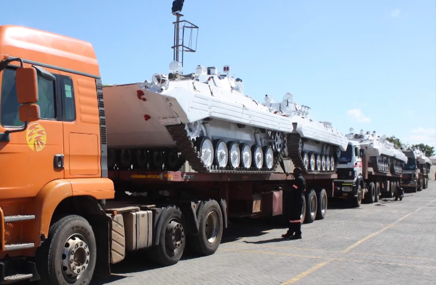 Heavy tracked vehicles secured on a line of low-loader trailers at Focus CFS, ready for onward movement.